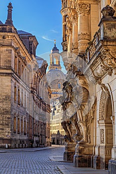 Cityscape - street view with sculptures of gatekeepers on the George Gate of Dresden Castle and the Dresden Frauenkirche