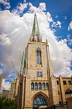 Cityscape of Tulsa Oklahoma USA with gothic chruch with copper spires in foreground