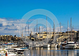 Cityscape of Valletta, the capital city of Malta, with sailboats and yahts in harbor in sunny day with blue sky in sunny day, EU,