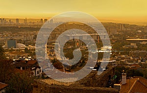 Cityscape view from Ankara Castle in yellowish sky background in evening