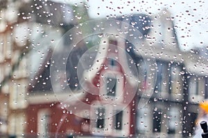 Cityscape - view on the old houses of Amsterdam in the rain through motorcycle windshield