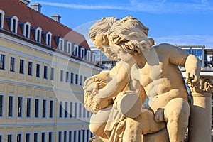 Cityscape - view of the sculpture of a pair of cupids against the backdrop of Dresden Castle close-up