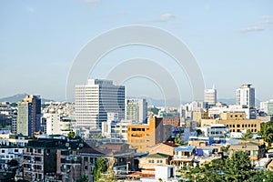 Cityscape View of Seoul from mid-level with biuildings and scyscrapers on a sunny day