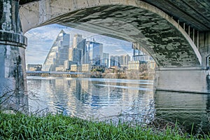 Cityscape view under the arched bridge with string lights over the Colorado River- Austin, Texas