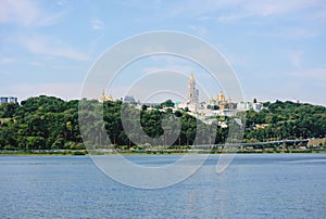 Cityscape from the water of Kyiv-Pechersk Lavra on green hee