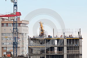 Cityscape with workers and incomplete building at photo