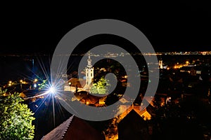 Cityscape of Zemun and St. Nicholas church at night.