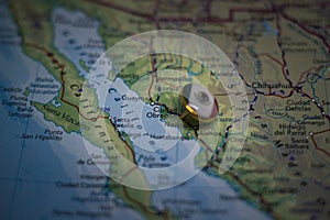Ciudad Obregon pinned on a map with the flag of Mexico photo