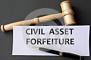 CIVIL ASSET FORFEITURE - words on white paper on dark background with judge's gavel