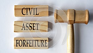 CIVIL ASSET FORFEITURE - words on wooden blocks on a white background with a judge's gavel