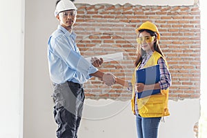 Civil Construction engineer teams shaking hands together wear work helmets worker on construction site. Foreman industry project