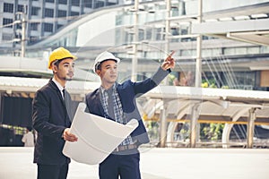 Civil Construction engineer teams shaking hands together wear work helmets worker on construction site. Foreman industry project