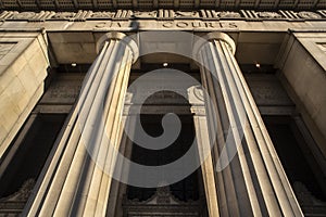 Looking up at Civil Courts building with stone Greek flutted columns and ornate design