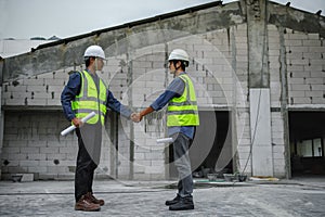 Civil Engineer with contractor partners are shaking their hands in construction building, agreement of partners in contract.