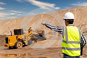 Civil Engineer control work of Yellow Excavator working at sandpit. sand industry. construction site