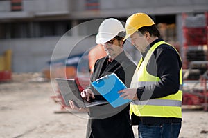 Civil engineer giving instructions to construction worker