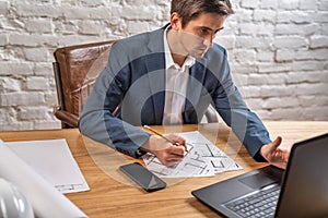 Civil engineer at his Desk working with documents