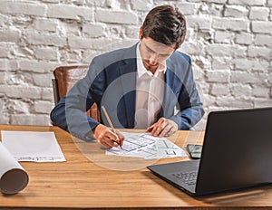 Civil engineer at his Desk working with documents