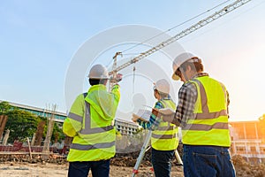 Civil engineer inspects work using radio communication with the management team in the construction area photo