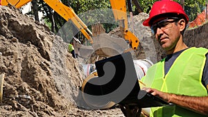 Civil Engineer With Laptop Computer at Construction Site