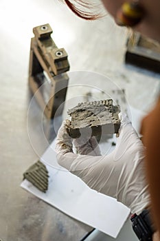 Civil engineer performing a laboratory test for shear strength determination and observing the soil after testing