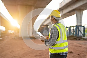 A civil engineer or supervise inspected the structure road at new road construction