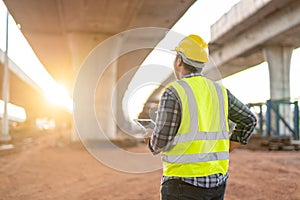 A civil engineer or supervise inspected the structure road at new road construction