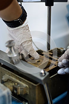 Civil engineer using a direct shear test box for soil parameters determination.