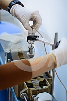 Civil engineer using a direct shear test box for soil parameters determination.