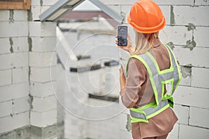 Civil engineer using her cellphone at work