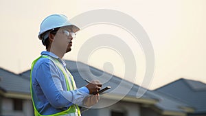 Civil engineer work inspecting architect drawing on construction site.