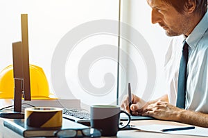 Civil engineer working with sketch pen tablet in architecture of