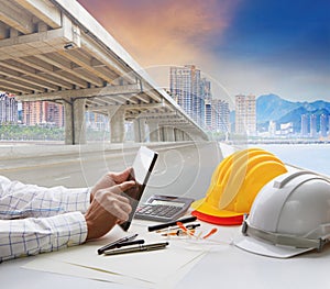civil engineer working table and urban building with infra structure development photo