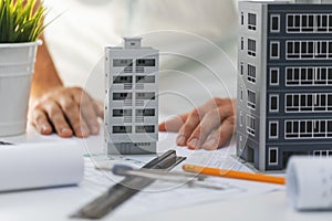 Civil engineering housing development - house scale models and blueprints on the desk