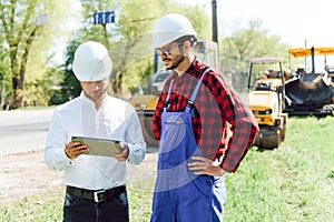 Civil engineering, road construction. The concept of building a new asphalt road. Road repair. Road service worker near the rink