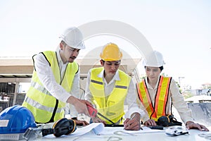 Civil engineering team meets to plan work on construction project in the construction area Foreman, industrial project