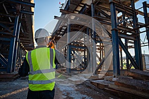 A civil engineering working at structure construction of road construction site. Supervise inspect new road construction sites.