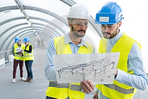 Civil engineers studying tunnel design