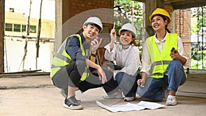 Civil engineers team wearing safety helmets and vests inspecting construction site. Industry, Engineer, construction