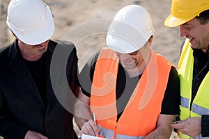 Civil engineers writing on a notebook