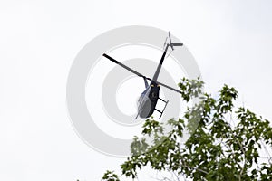 Civil helicopter flying at low altitude 