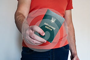 Civil man holding ukrainian military id. Soldier, mobilization