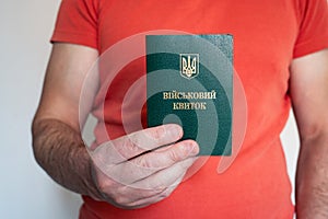 Civil man holds ukrainian military id. Soldier, mobilization