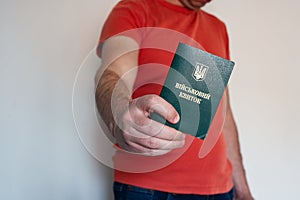 Civil man holds ukrainian military id. Soldier, mobilization