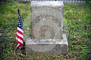 Civil War soldier cemetery gravestone with American Flag