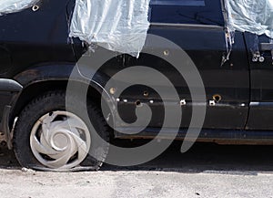 A civilian car was damaged by shrapnel from shelling by Russian troops.