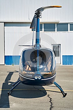 Civilian helicopter parked at vertiport in sunny weather photo