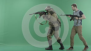 Civilian with machine gun caughts terrorist with a weapon against chromakey background