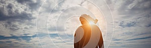 Civilian man wearing military gas mask, loss ozone layer, sun is dangerous. Human silhouette in a gas mask against moody sky.