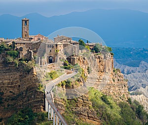 The famous Civita di Bagnoregio hit by the sun on a stormy day. Province of Viterbo, Lazio, Italy. photo